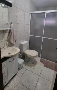 a bathroom with a shower and a toilet and a sink at Kamke's Haus III in Pomerode