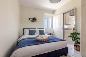 a bedroom with a bed with a basket on it at Doma Rooftop Apartment in Heraklio Town