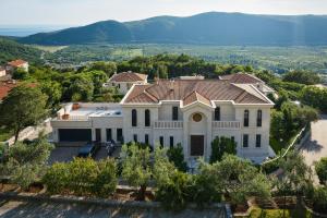 an aerial view of a mansion with mountains in the background at Eterno Villas in Budva
