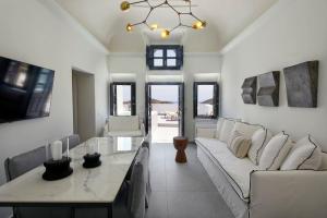 a living room with a couch and a table at Lerion Luxury Villas in Akrotiri