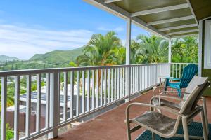 a balcony with chairs and a view of the mountains at Ka Hale me Ka ike 30 Night Minimum in Kaneohe