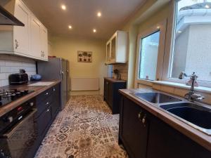 a kitchen with a sink and a counter top at Charming 4-Bed Victorian House in Retford in Retford