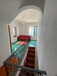 uma escada com um sofá vermelho num quarto em Casa Laura em Positano