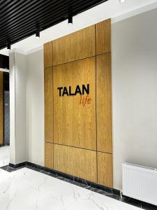 a wooden wall with the word talan on it at Talan life aparts in Atyraū