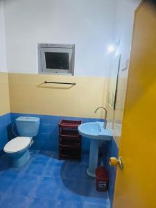 Baño azul con aseo y lavamanos en Susha Happy One 2BR First Floor Apartment, en Hikkaduwa
