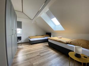 a bedroom with two beds and a skylight at Haus Mariechen in Frielendorf