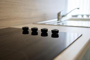 a counter top with four black cups on it at Douglas Gatehouse in Douglas