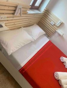 a small bed in a room with a window at MIRIS home fast and comfortable with self check in 8 minutes walk near Naples airport in Naples