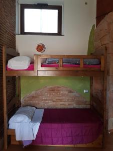 a bunk bed in a room with a brick wall at Bellavista in Acireale