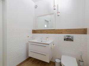 a white bathroom with a sink and a toilet at Cztery Luksusowe Domy na Mazurach, jezioro Juksty - SAKURAREST in Sniadowo
