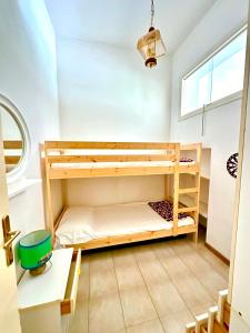 a bedroom with two bunk beds and a window at Appartamento Mareadi in Marina di Grosseto