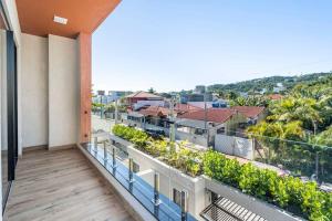 an apartment balcony with a view of a city at Casa Neves em Bombas in Bombinhas