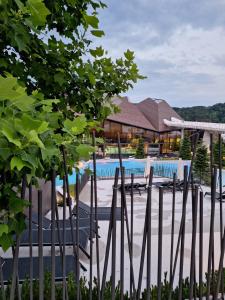 a resort with a swimming pool and a building at Apartma Mia, Aparthotel Rosa in Podčetrtek