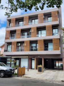 an apartment building with a car parked in front of it at FINCA NOVA Apartment 2 in Balcarce