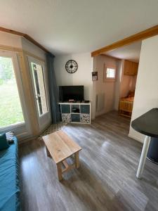 a living room with a couch and a table at Bonheur des Orres 1650 in Les Orres
