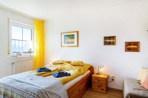 a bedroom with two beds and a window at Relaxen am Illmensee in Illmensee