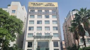 a tall white building with a sign on it at The Place Gurugram, a member of Radisson Individuals in Gurgaon