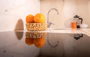a basket of oranges on a counter in a kitchen at COSA Zeyrek- Home at the heart of Istanbul in Istanbul
