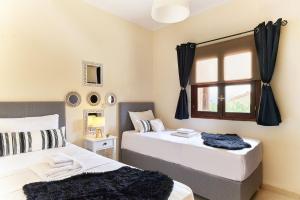 Ένα ή περισσότερα κρεβάτια σε δωμάτιο στο Dreamscape Residences - Villas