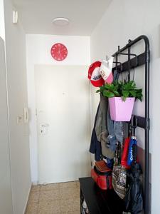 a closet with a rack of shoes and a plant at Cozy apartment with good vibe in Ashdod