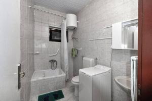 a small bathroom with a toilet and a sink at Apartment 'Dan' in Zlarin