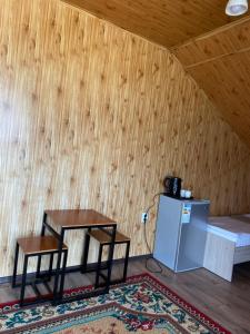 a room with two tables and a refrigerator at Eram Garden Hotel in Bosteri +48 photos