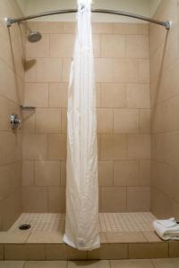 a shower with a white shower curtain in a bathroom at Running Y Ranch Golf & Spa Resort in Klamath Falls