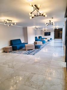 a lobby with blue chairs and a waiting room at Zar in Amanzimtoti