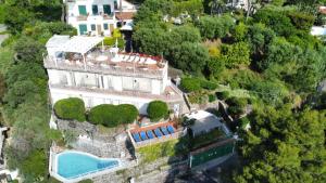an aerial view of a house with a swimming pool at Don Felipe Boutique Hotel in Ischia Town