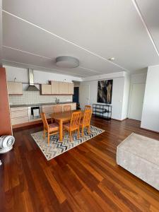 a living room with a wooden table and chairs at Ringi 37 Riverview Holiday Apartments in Pärnu
