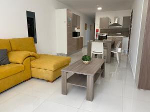 a living room with a couch and a table at Sunrise Court in Marsaskala