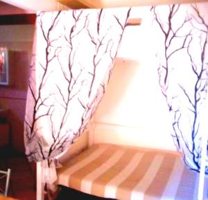 a bed with a canopy in a room at Alba Sweet in Alba Adriatica