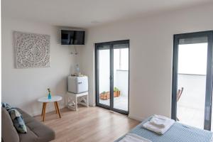 a living room with a couch and a table at Beach & Sea Guesthouse in Espinho