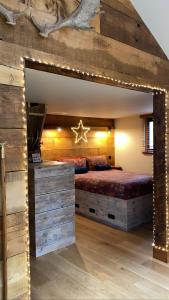 a bedroom with a large bed with christmas lights at Keepers Cabin - Hot tub in Kings Lynn