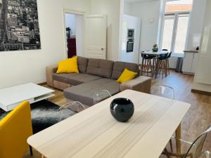 a living room with a couch and a table at COSY T3 Centre Reims/Pkg Privé in Reims