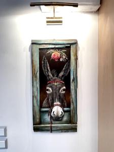 a painting of a donkey on a wall at LIVING IN A CAVE UNDER ACROPOLIS in Athens