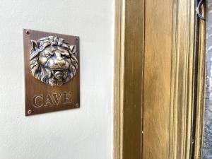 a plaque with a lion head on a wall at LIVING IN A CAVE UNDER ACROPOLIS in Athens