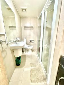 a bathroom with a toilet and a sink and a shower at Inspiria in Davao City