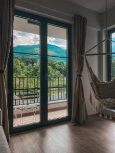 a room with a window with a hammock and a view at Vitosha View Apartment & Free Parking in Sofia