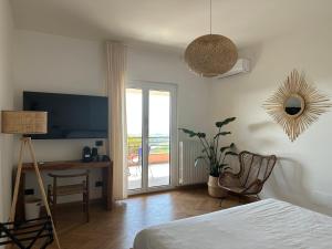 a bedroom with a bed and a desk and a television at Vistalago in San Lorenzo Nuovo