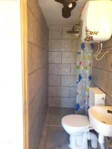 a bathroom with a toilet and a sink at Forest edge in Saugos
