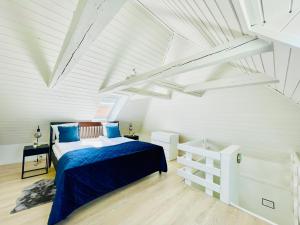a bedroom with a bed in a white attic at aday - Modern 1 Bedroom Charming Central Apartment with Public Parking in Aalborg