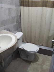a bathroom with a toilet and a sink at Appart-hotel Veras Samana No14 in Santa Bárbara de Samaná