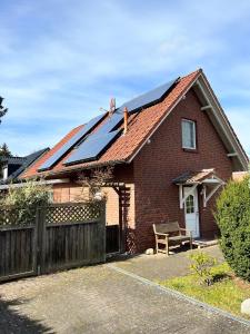 a red brick house with solar panels on the roof at Ferien_HAUS SEEOASE in Göhren-Lebbin