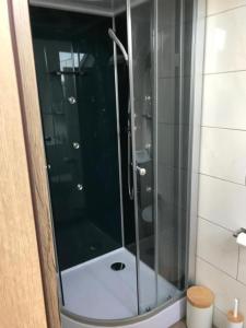 a shower with a glass door in a bathroom at Workers Sleep in Wilhelmshaven