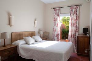 a bedroom with a white bed and a window at Hotel Madreselva - Grupo Califa in Los Caños de Meca +90 photos