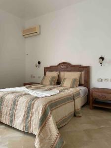 Ein Bett oder Betten in einem Zimmer der Unterkunft Villa avec piscine privée