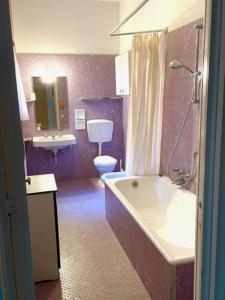 ein Badezimmer mit einer Badewanne, einem WC und einem Waschbecken in der Unterkunft Villa Il Platano con giardino Beachfront in Forte dei Marmi
