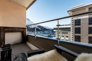 a balcony with a view of a city at Residence Au Reduit Sankt Moritz in St. Moritz