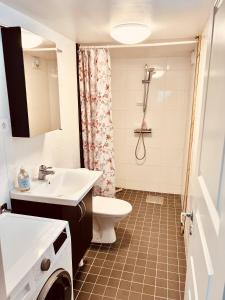 a bathroom with a sink and a toilet at Lovely 3-bed Flat In Stockholm in Sollentuna